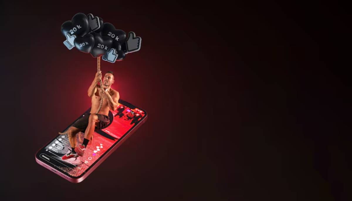 A shirtless person hangs from a rope attached to floating thumbs-up icons above a smartphone against a dark background.